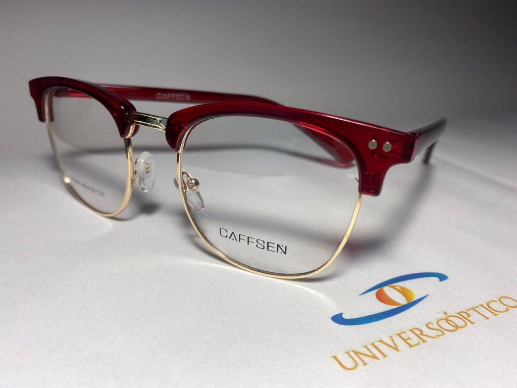Armazón UP124, de frente combinado: borde superior rojo y contorno inferior fino en dorado.