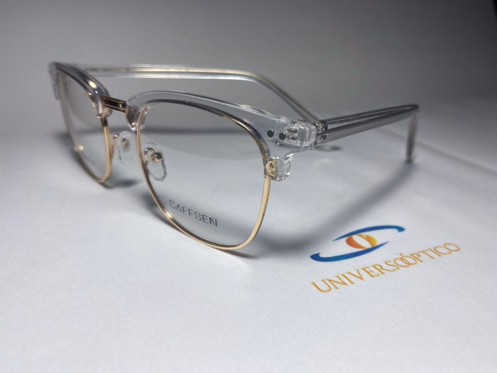 Armazón UP125, de frente combinado, con zona superior transparente y borde inferior fino dorado.